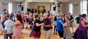 Contra dancers swinging at the Rose Room