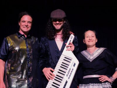 Zak, Alex, and Cat pose for the camera.