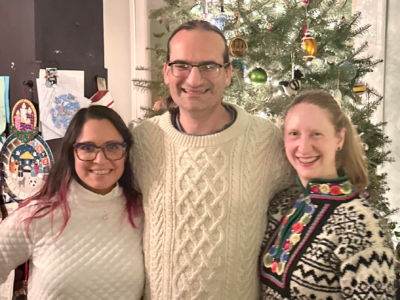 Nadia, Ross and Sarah wearing Christmas sweaters.