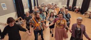 Dancers holding hands coming toward you