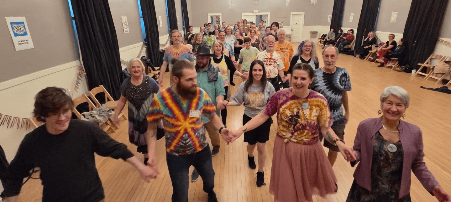 Dancers holding hands coming toward you