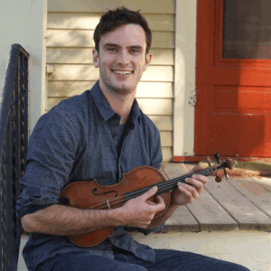 Ben Jackson with fiddle on porch