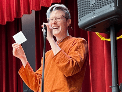 Smiling Qwill Duvall at the microphone